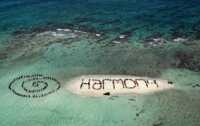 Hundreds of Belizians and international supporters gather on an island on the Barrier Reef off the coast of Belize City, Belize, on November 13, 2010. to form a human banner calling for humainity to be harmony with our natural world. The action was on the final day of the three-day Belize Reef Summit and is part of the launch of the Harmony Initiative, a partnership between the film "Harmony" narrated by Prince Charles, and the Global Campaign for Climate Action.   Photo by Lou Dematteis/Spectral Q/Handout